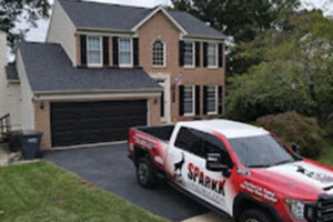 Sparkk Construction truck parked outside of two-story family home
