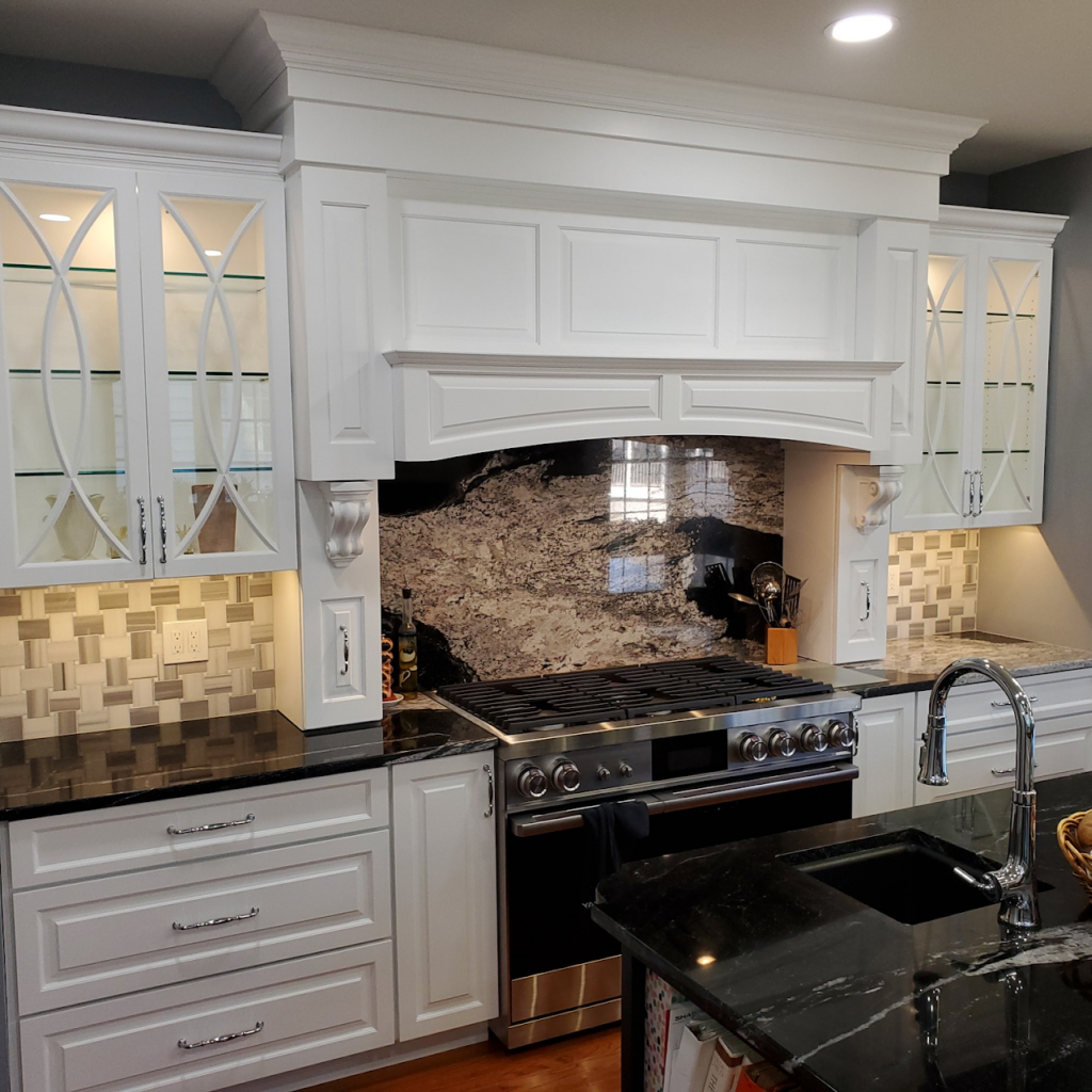 Decorative tile backsplash installation in a newly renovated kitchen by Sparkk Construction