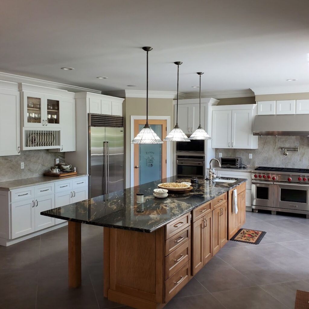 Large kitchen island installation with seating and stone countertops by Sparkk Construction kitchen remodelers