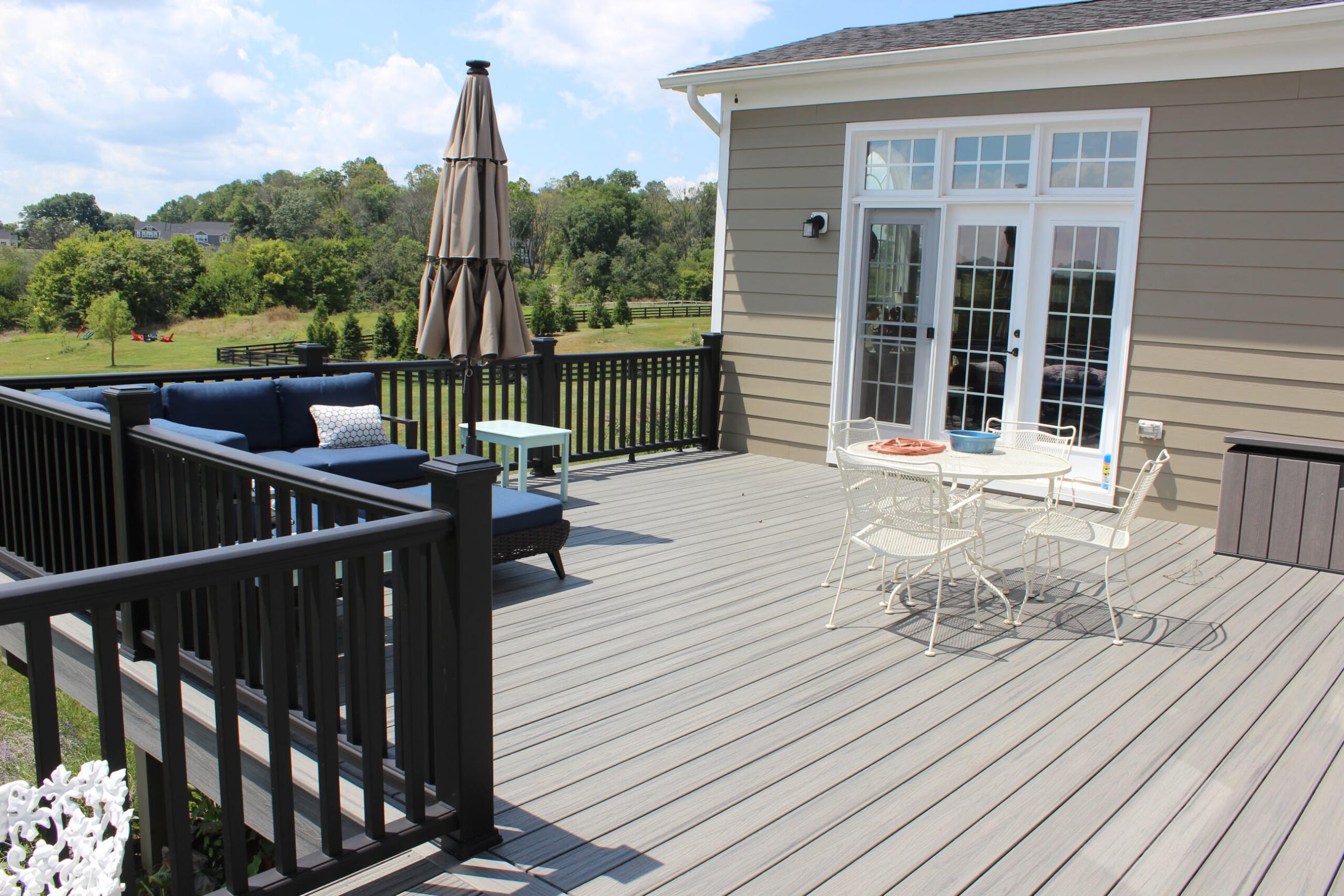 Completed custom composite deck with black railing and outdoor seating in Virginia