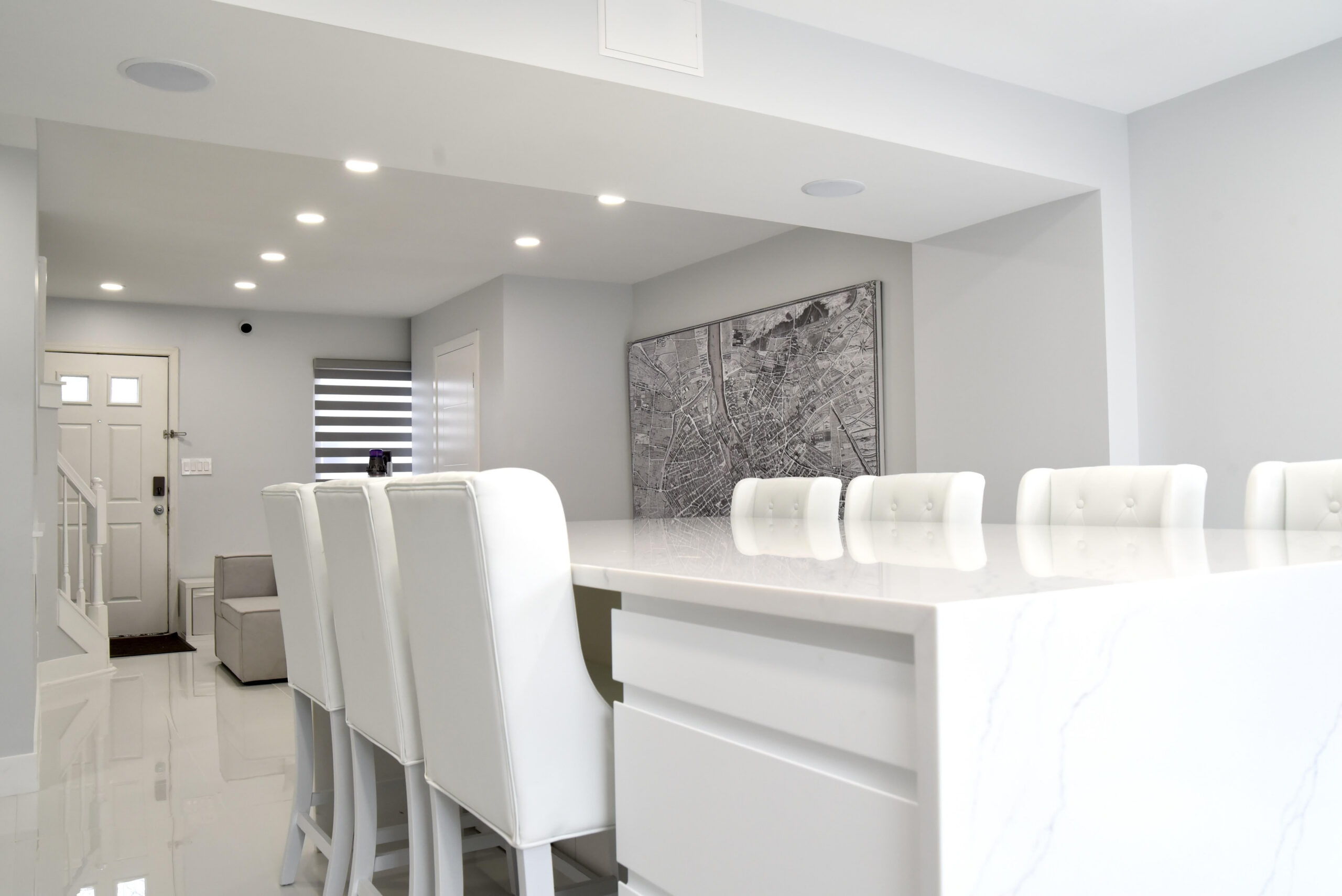 modern kitchen renovation completed by Sparkk Construction with white cabinets and quartz countertops